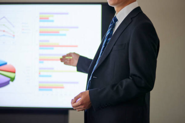 Japanese businessman wearing a suit giving a presentation